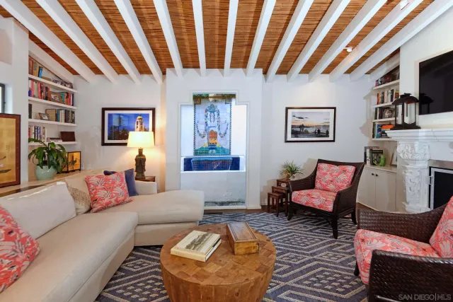 a living room with furniture pool table and flat screen tv