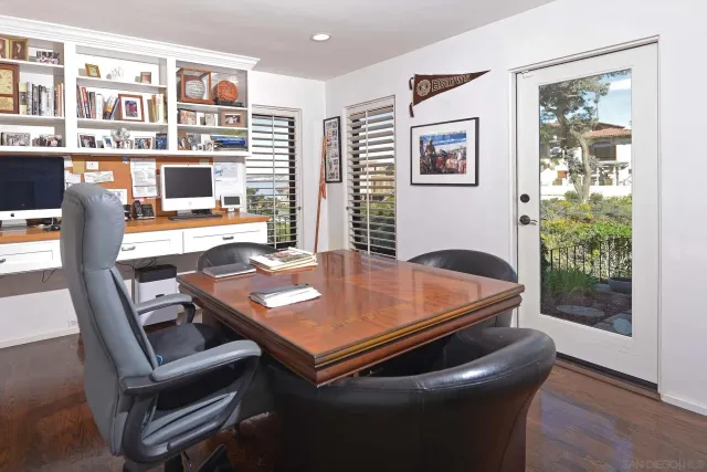 a view of a table and chairs under an umbrella in patio