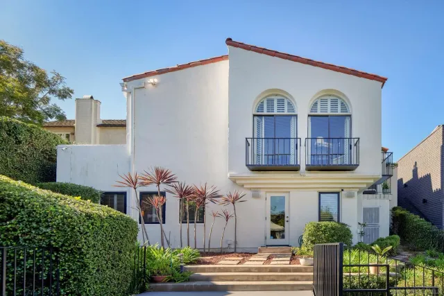 a living room with a mirror and a potted plant