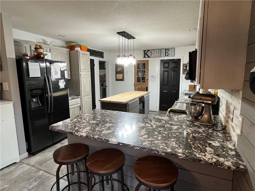 129 Maple Street Rices Landing, PA 15357 - Photo 5 of 18 a kitchen with stainless steel appliances granite countertop a refrigerator and a stove top oven