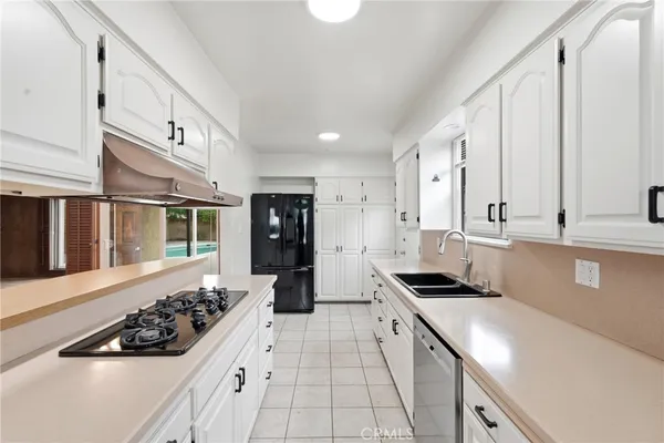 a kitchen with a sink stove and refrigerator