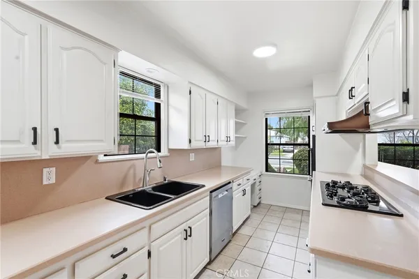 a kitchen that has a sink and a stove in it