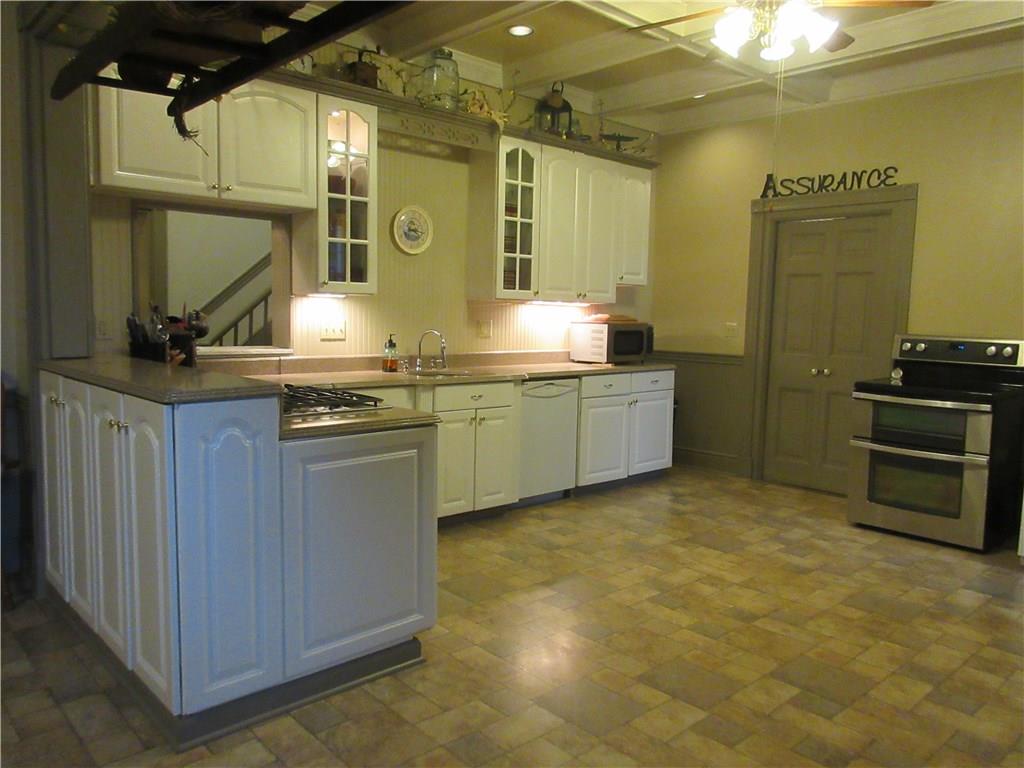 540 Freeport Road Freeport, PA 16229 - Photo 12 of 25 Huge eat-in kitchen with Vanguard countertops, a gas cooktop and double oven, coffered beamed ceilings with recessed lighting and ceiling fans with lights.