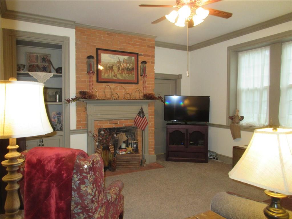 540 Freeport Road Freeport, PA 16229 - Photo 5 of 25 Living room with built-ins, ceiling fan with light, and crown molding.