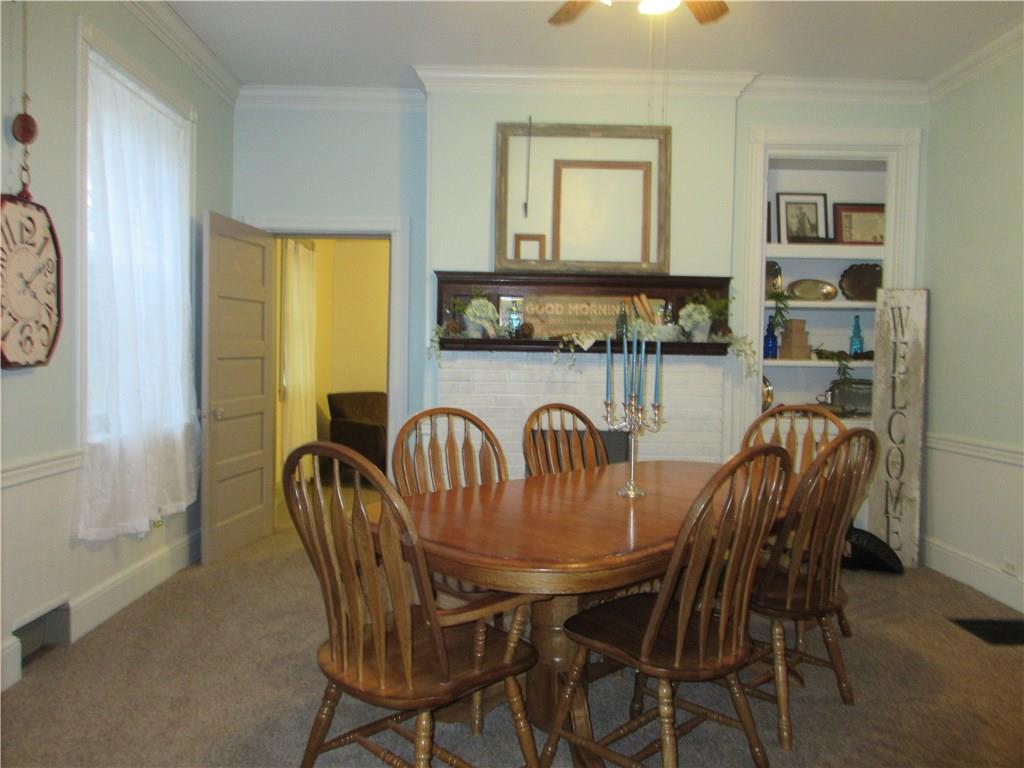 540 Freeport Road Freeport, PA 16229 - Photo 7 of 25 Dining room with crown molding, ceiling fan with light and built-ins.