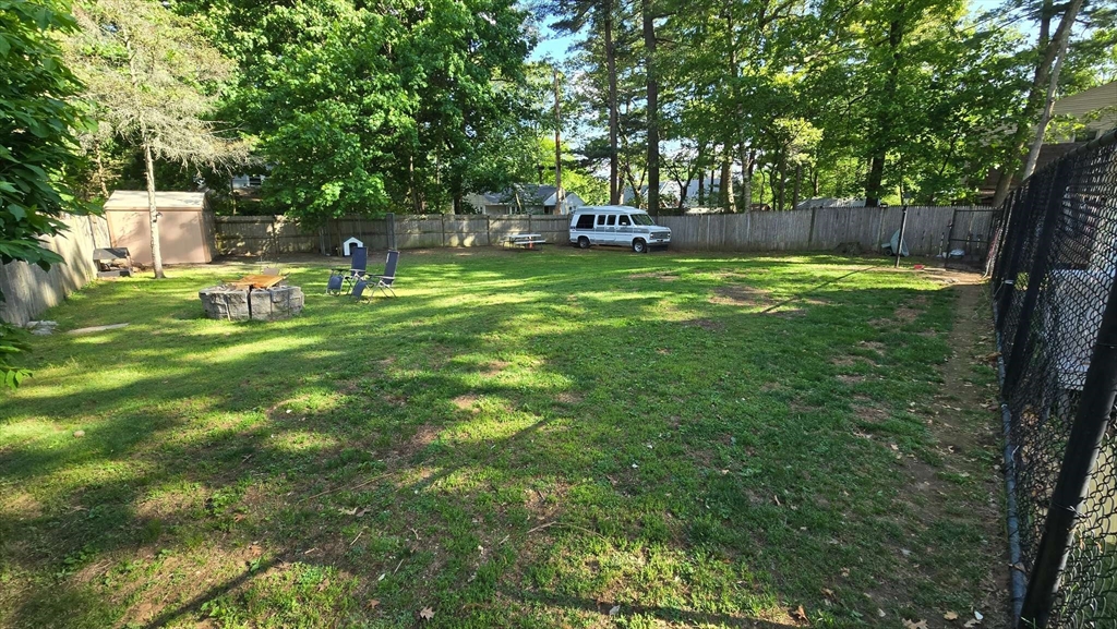 32 Birch Road Natick, MA 01760 - Photo 31 of 38 a view of a garden with a bench