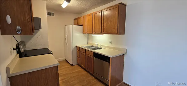 a kitchen with a sink and a refrigerator