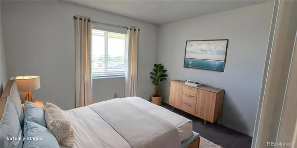 a bedroom with a bed and a potted plant