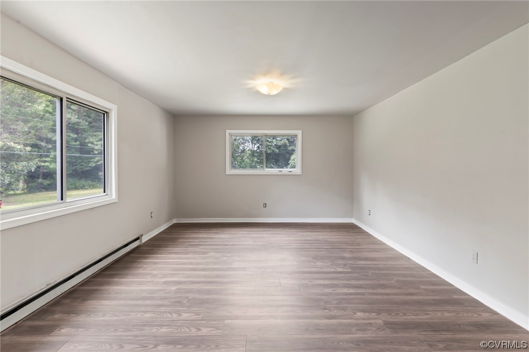 11111 Reedy Branch Road Chesterfield, VA 23838 - Photo 7 of 13 a view of an empty room with wooden floor and a window