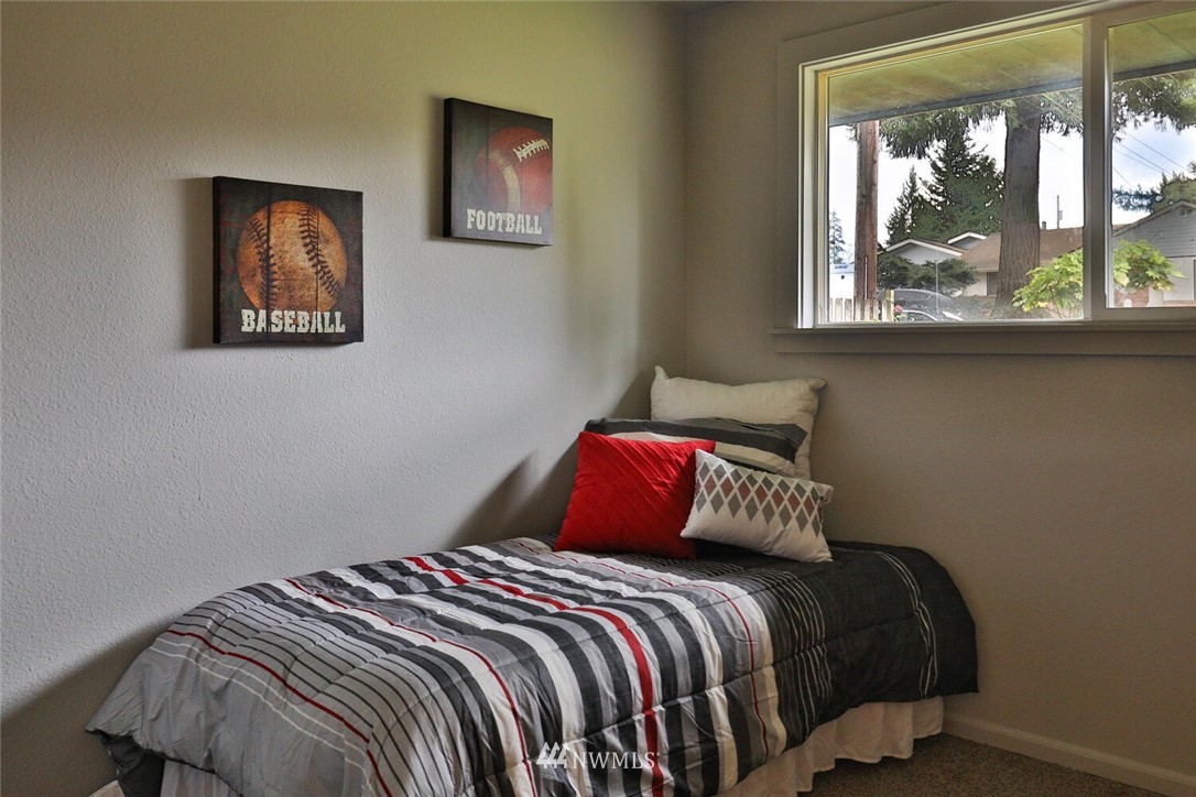 6527 Tyee Road Everett, WA 98203 - Photo 14 of 37 a bedroom with a bed and a window
