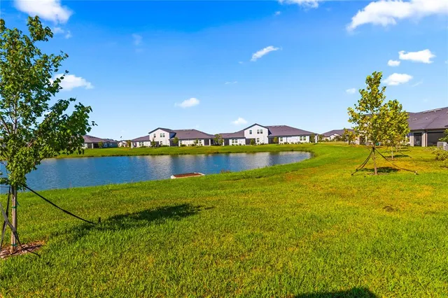 a view of a lake with houses in the back