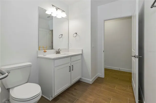 a bathroom with a sink a toilet a mirror and shower