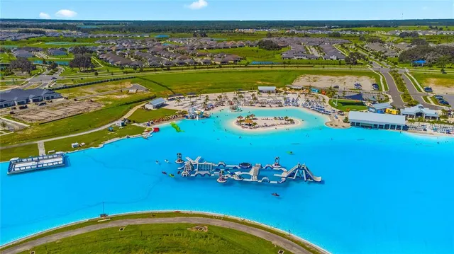 an aerial view of a residential houses with outdoor space swimming pool
