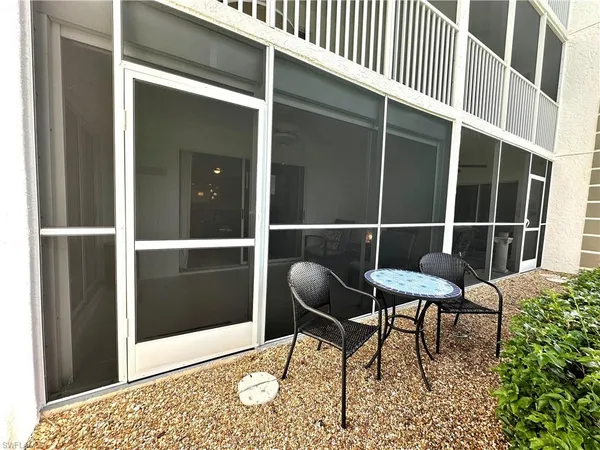 a chair and a table in a balcony