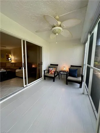 a living room with furniture and a ceiling fan