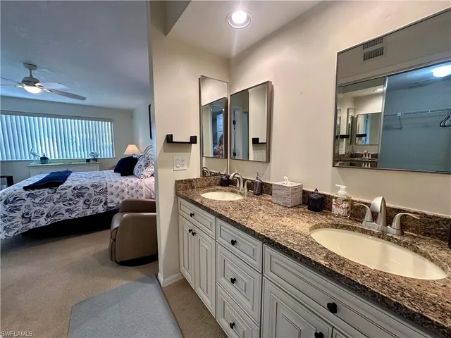 a en suite bathroom with double sink and a large mirror