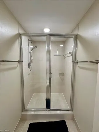 a bathroom with a glass shower door