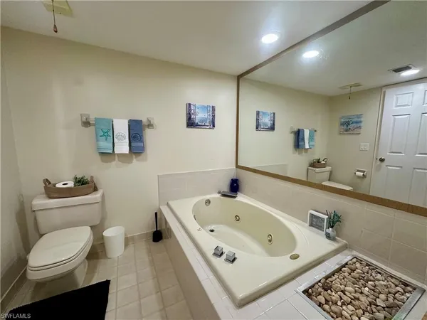 a white bath tub sitting next to a white toilet