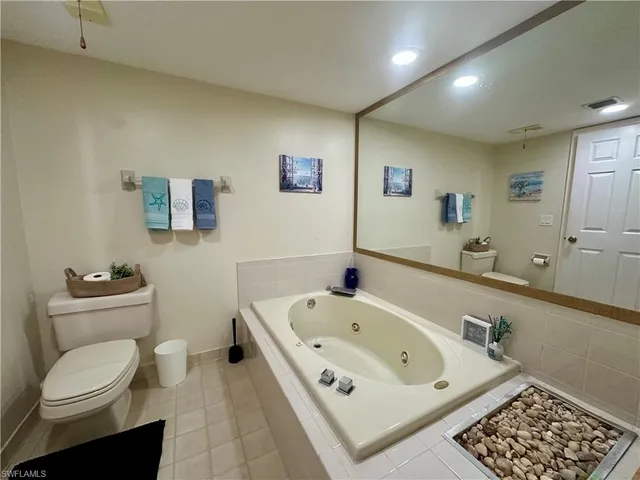 a white bath tub sitting next to a white toilet