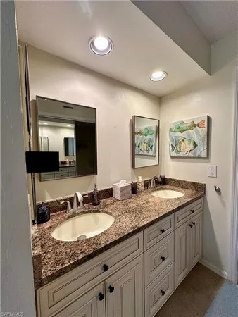 a bathroom with double sink and a mirror