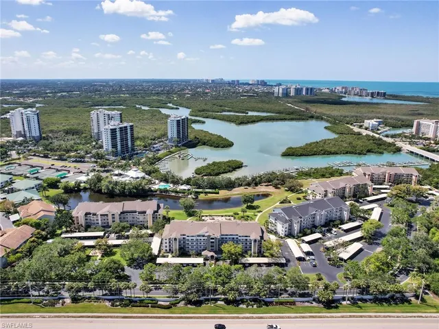 an aerial view of a houses with a lake view