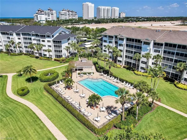 an aerial view of a house with swimming pool outdoor seating and yard