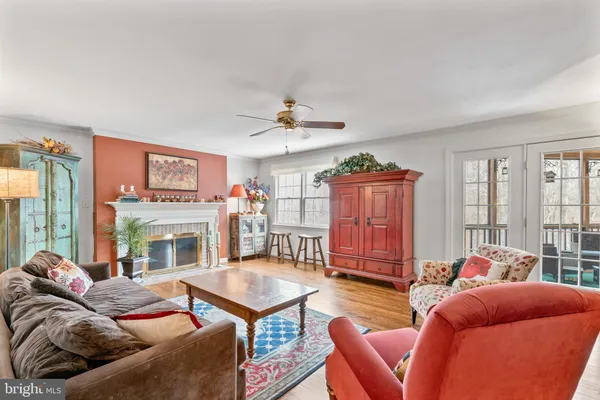 a living room with furniture a fireplace and a large window