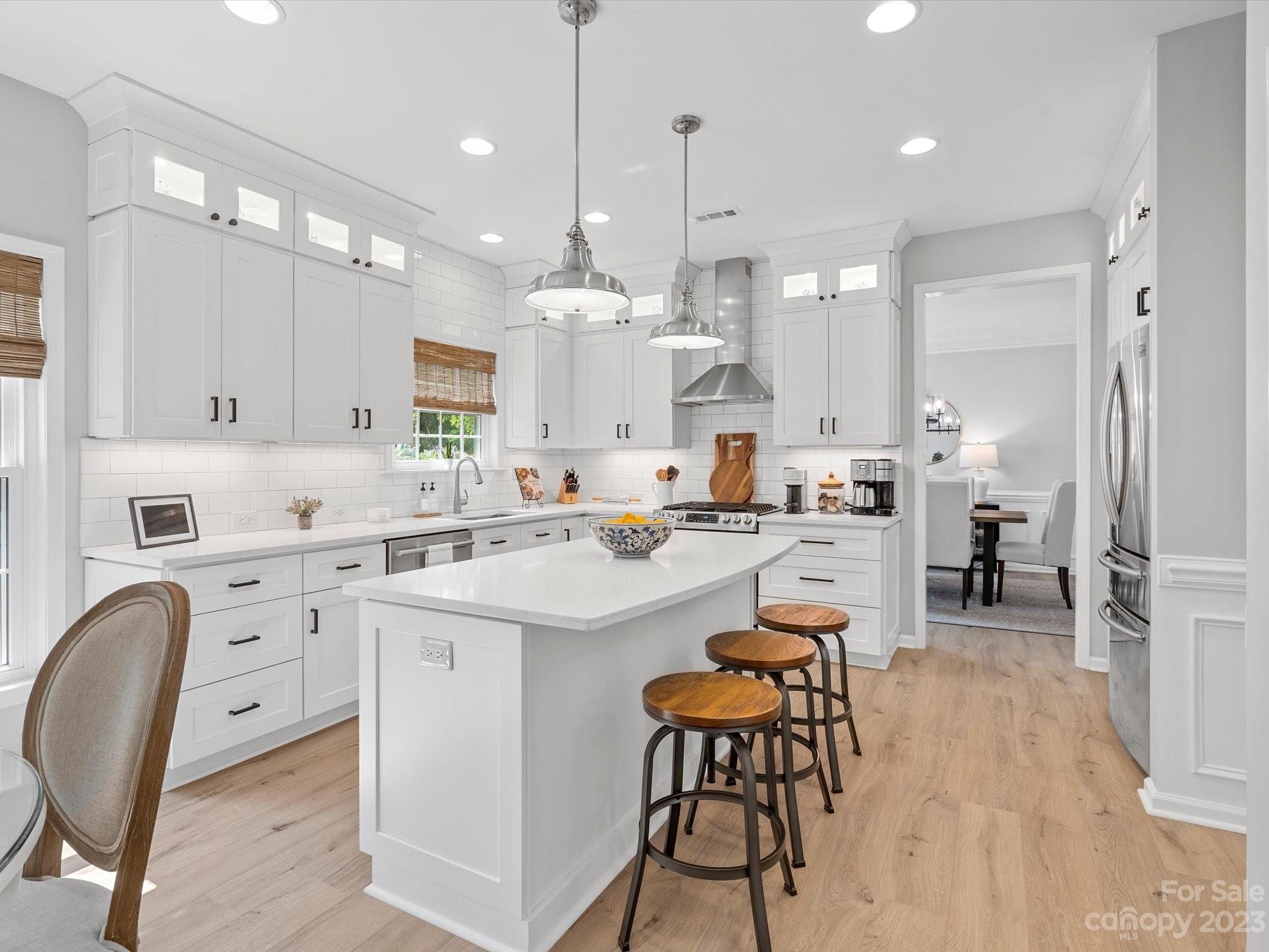 815 Circle Trace Road Monroe, NC 28110 - Photo 11 of 48 a large white kitchen with lots of counter space a dining table and appliances