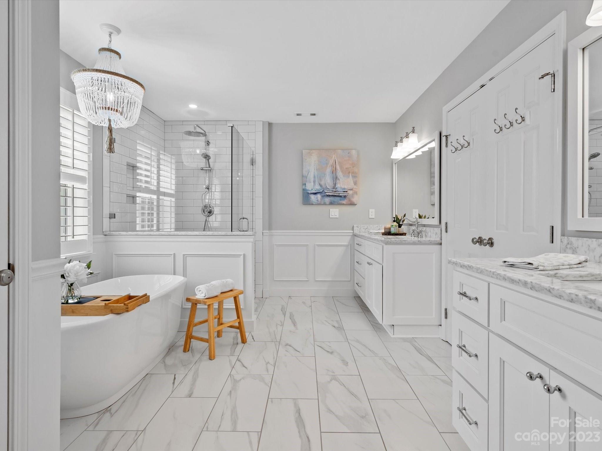 815 Circle Trace Road Monroe, NC 28110 - Photo 27 of 48 a spacious bathroom with a granite countertop sink a mirror a bathtub and next to a window