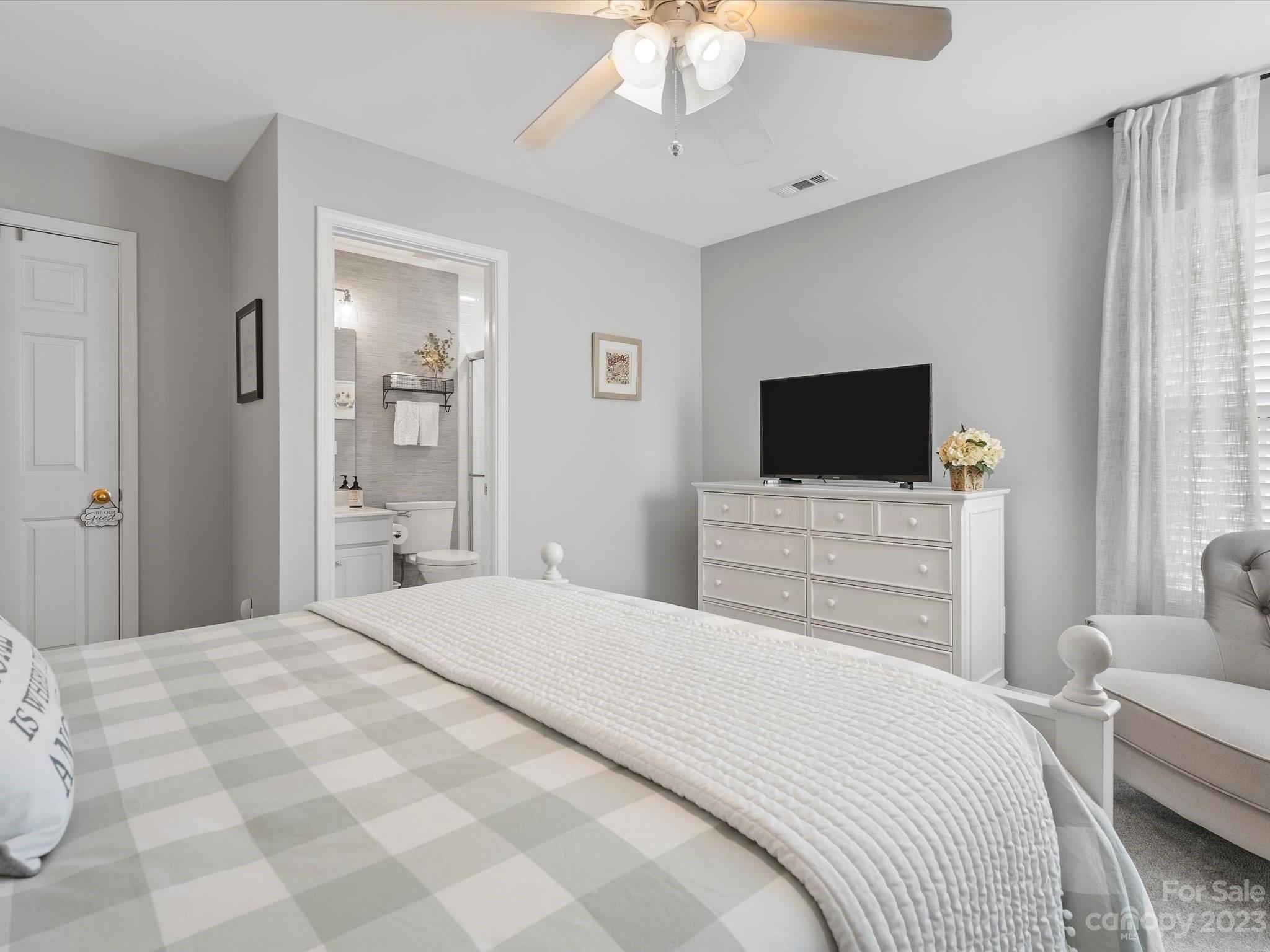 815 Circle Trace Road Monroe, NC 28110 - Photo 37 of 48 a bedroom with a bed a tv and wooden floor