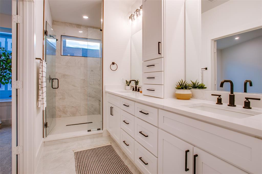 2130 Shea Road, Unit 1002 Dallas, TX 75235 - Photo 5 of 39 a bathroom with a shower sink and mirror