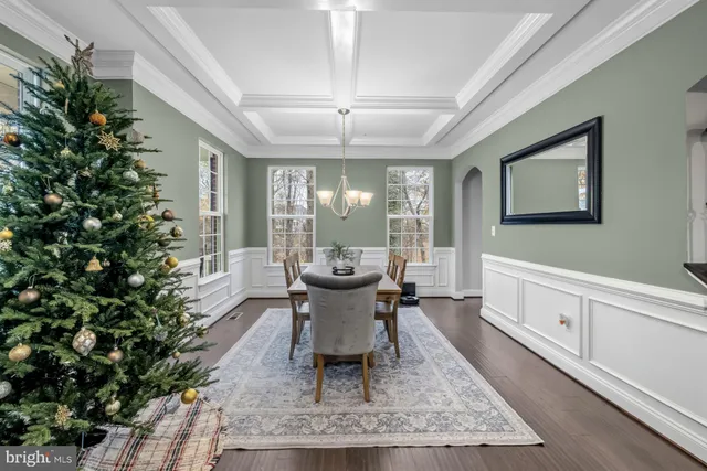 a living room with furniture and a view of kitchen