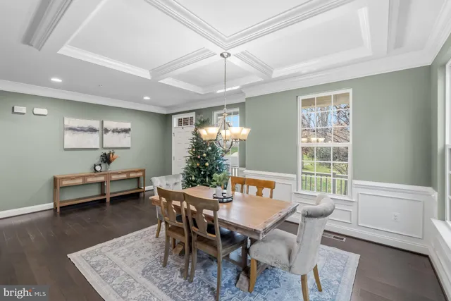 a kitchen with stainless steel appliances refrigerator and wooden floor