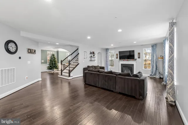 a kitchen with stainless steel appliances granite countertop a sink a stove and a wooden floors