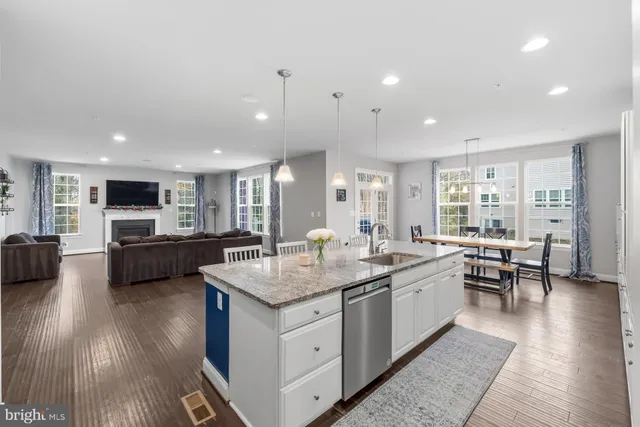 a bathroom with a toilet sink vanity and mirror