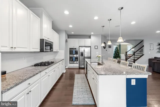 a en suite bathroom with a granite countertop sink mirror and toilet