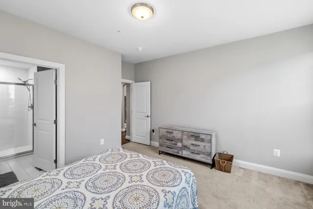 a spacious bedroom with a bed and a chandelier