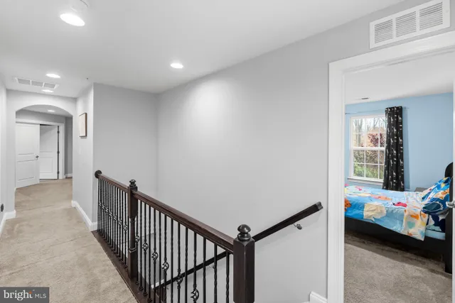 a spacious bathroom with a granite countertop sink mirror and shower