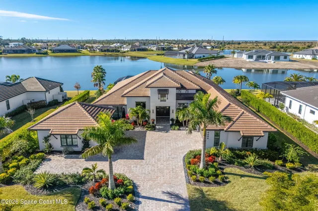 a kitchen with stainless steel appliances a stove a sink dishwasher and white cabinets with wooden floor