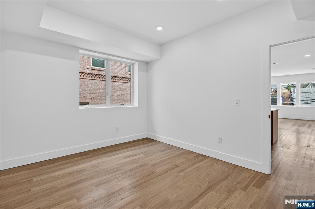 46 Hudson Avenue, Unit B Edgewater, NJ 07020 - Photo 10 of 30 wooden floor in an empty room with a window