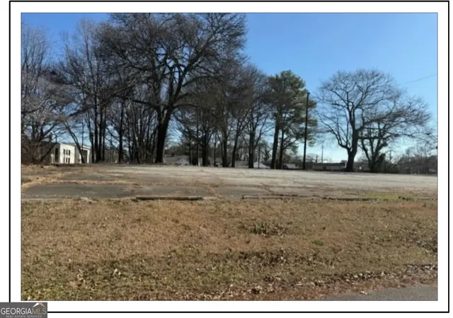 a view of dirt yard with a trees
