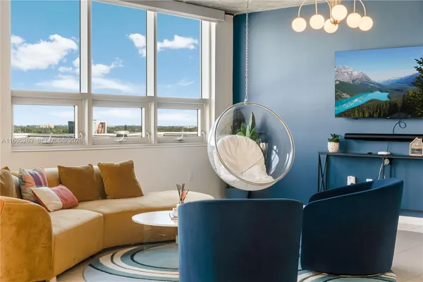 a living room with furniture and a flat screen tv
