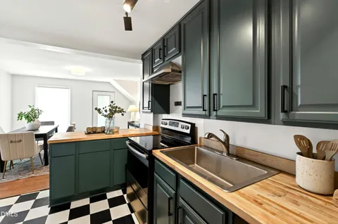 a kitchen with a sink and a stove top oven