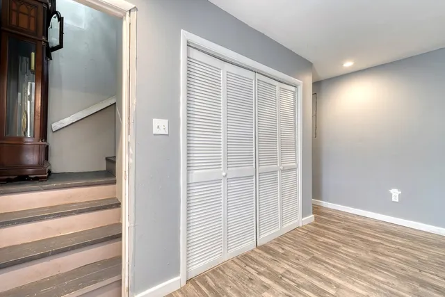 a view of a room with wooden floor and staircase