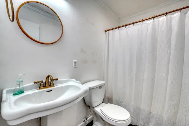 a white toilet sitting next to a bathroom sink