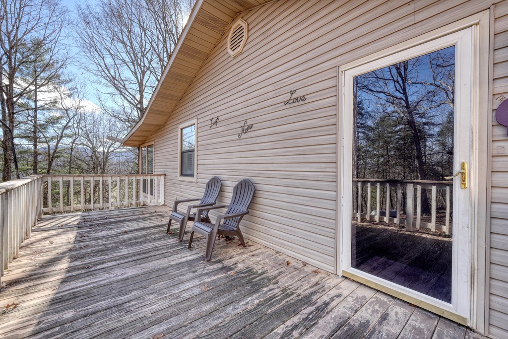 131 Hickory Ridge Circle Hayesville, NC 28904 - Photo 6 of 35 a view of a chair and tables in the balcony