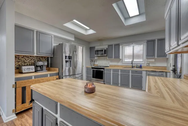 a kitchen with a refrigerator and a sink