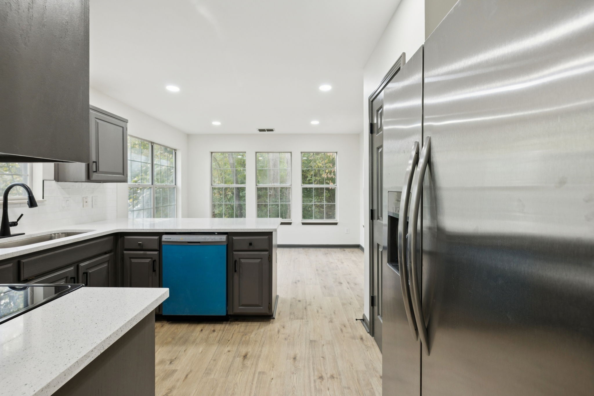 4612 Raccoon Trail Hermitage, TN 37076 - Photo 14 of 36 a large kitchen with stainless steel appliances granite countertop a refrigerator a sink a stove and island