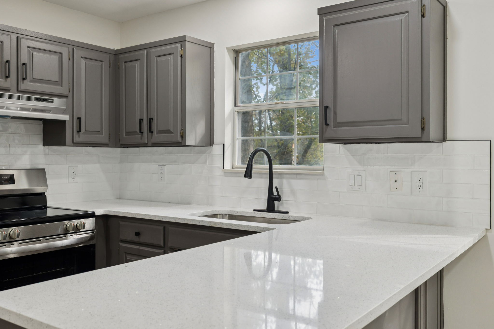 4612 Raccoon Trail Hermitage, TN 37076 - Photo 15 of 36 a kitchen with stainless steel appliances a sink a stove and a refrigerator