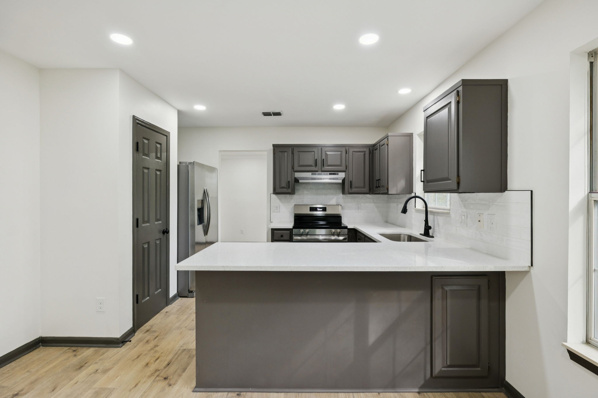 4612 Raccoon Trail Hermitage, TN 37076 - Photo 16 of 36 a kitchen with stainless steel appliances a sink stove and refrigerator